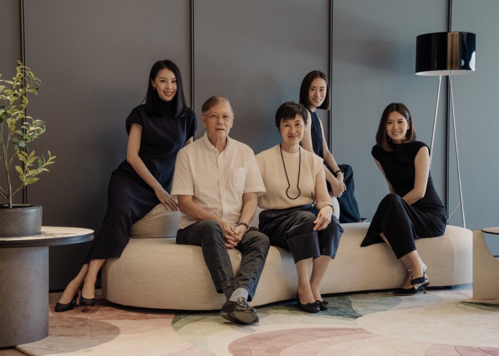 a 5 member family portrait of parents with their 3 daughters