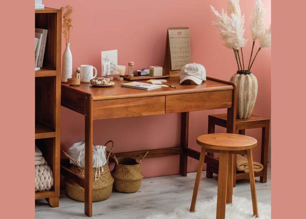 a wooden study table with many objects on it