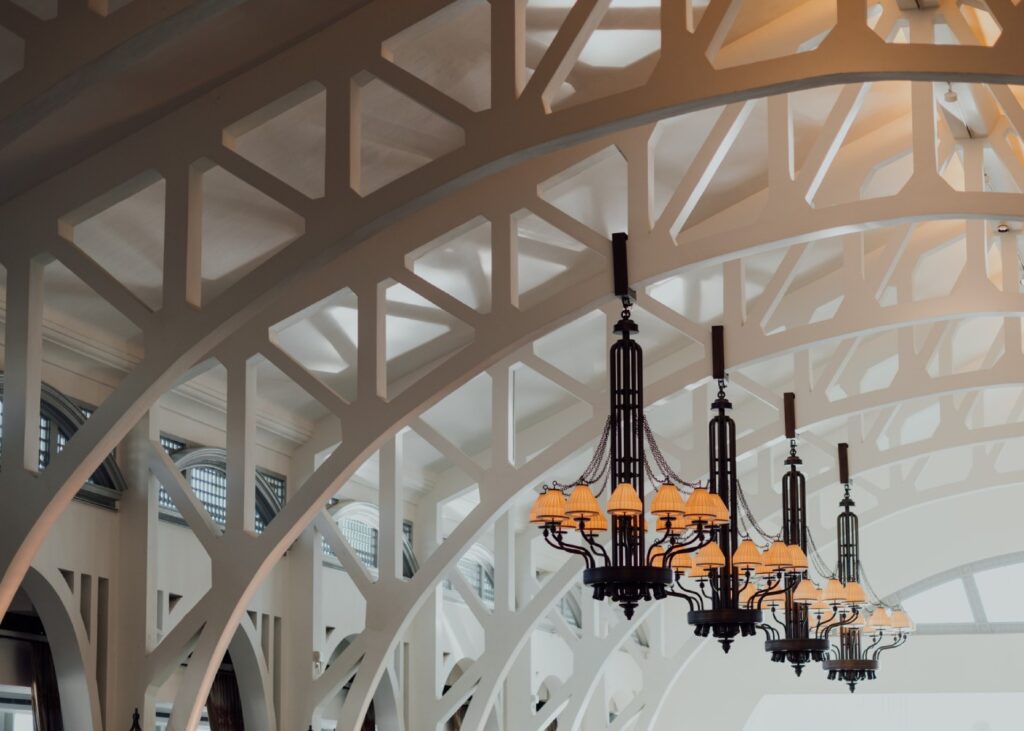 view of the arches inside a heritage building and black chandeliers