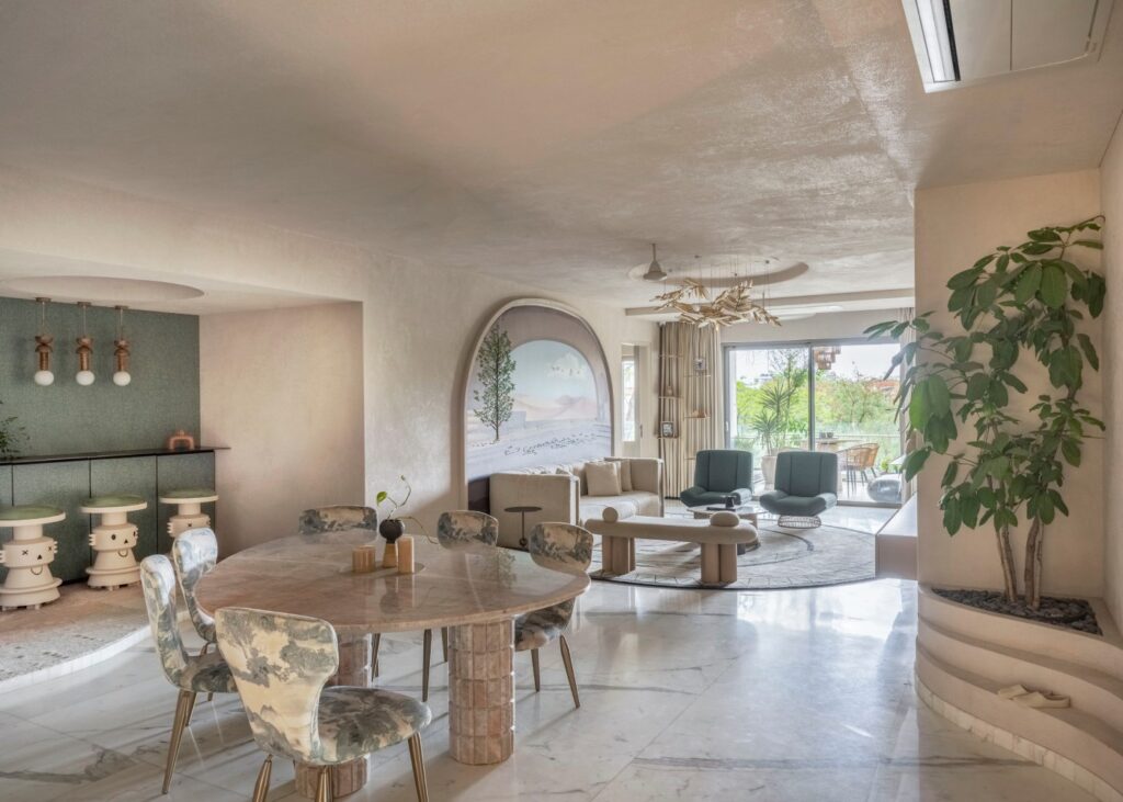 view of the dining, bar and living space of a luxury apartment in light cream tones