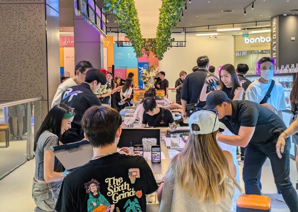 many people in a computer keyboard showroom making their own keyboards