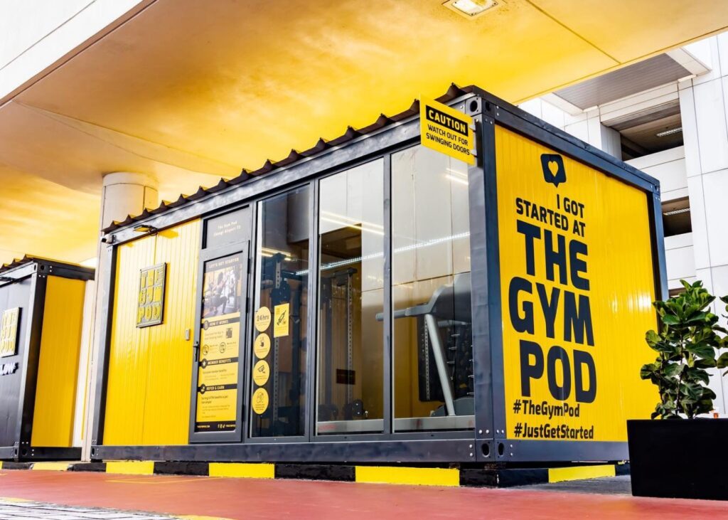 a yellow shipping container converted into an indoor gym