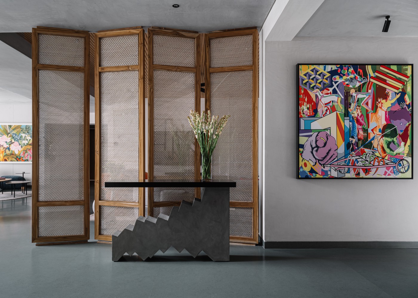 view of the entry lobby of a designer home finished with grey tones and decorated with vibrant objects