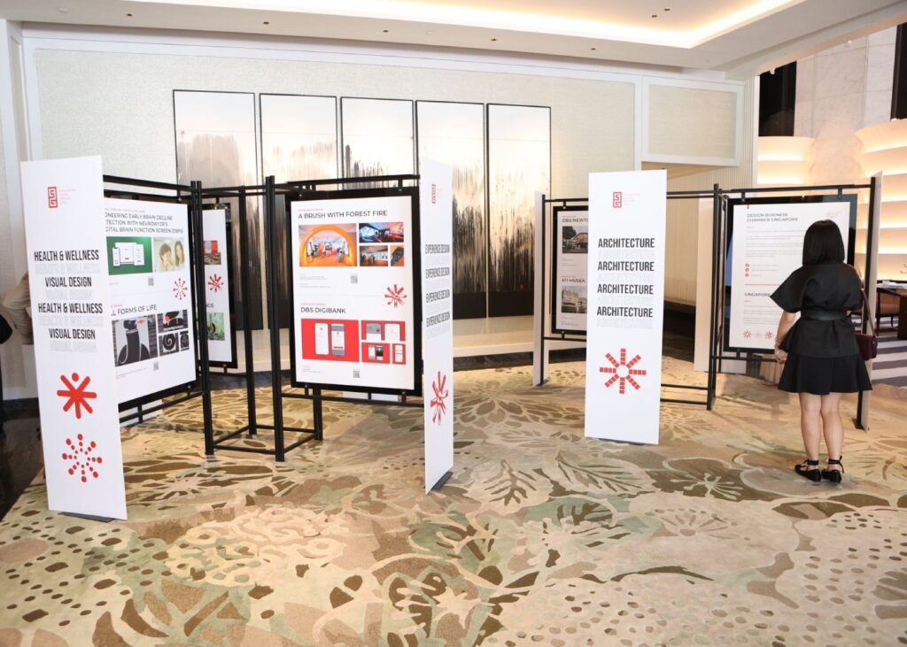 a woman looking through a design exhibition