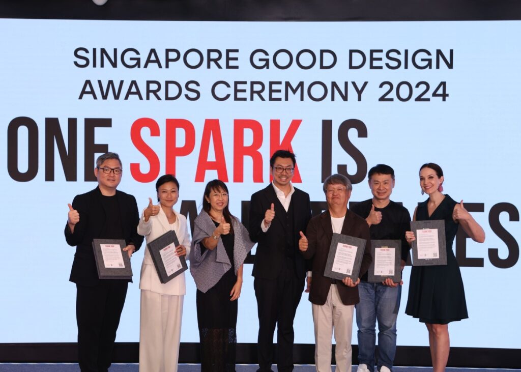 a group of award presenters standing on a stage