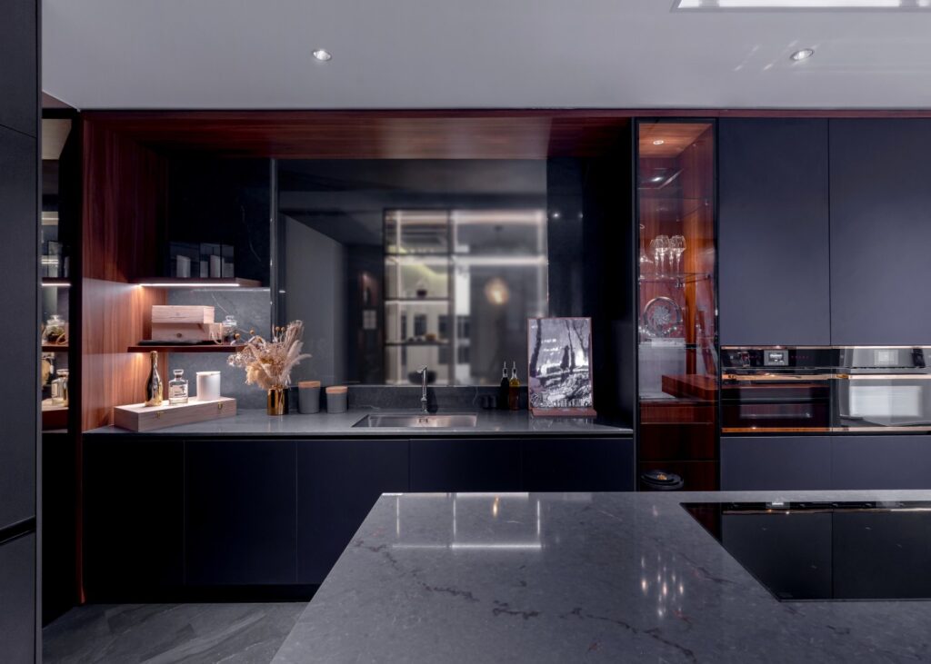 design of a modern kitchen in dark grey tones and tech forward equipment