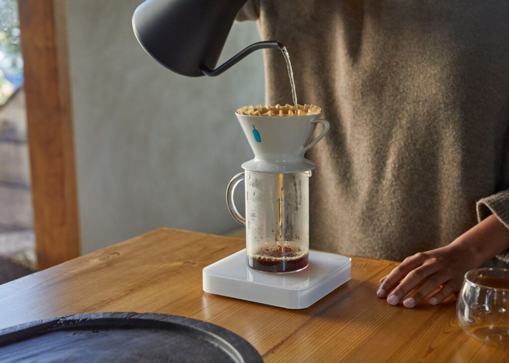 woman pouring coffee into a cup