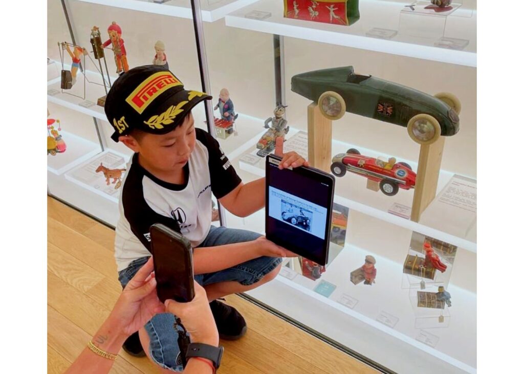 a child studying some toys at a pop up museum