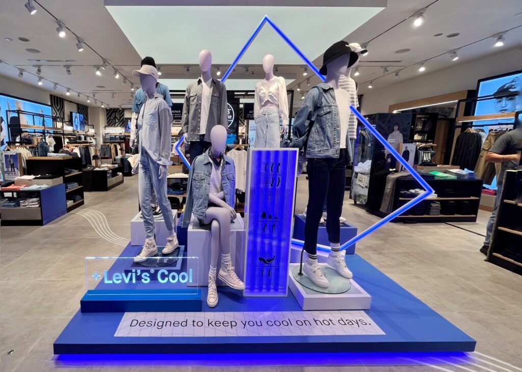 group of mannequins in blue colored apparel at a store