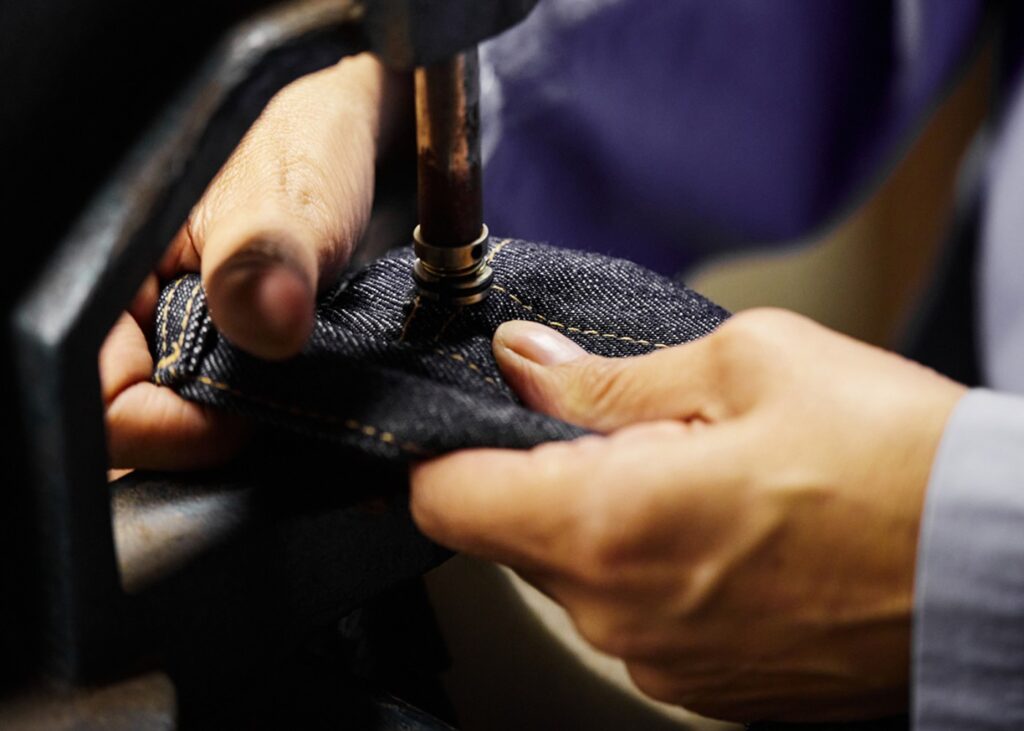 tailor tailoring a pair of trousers