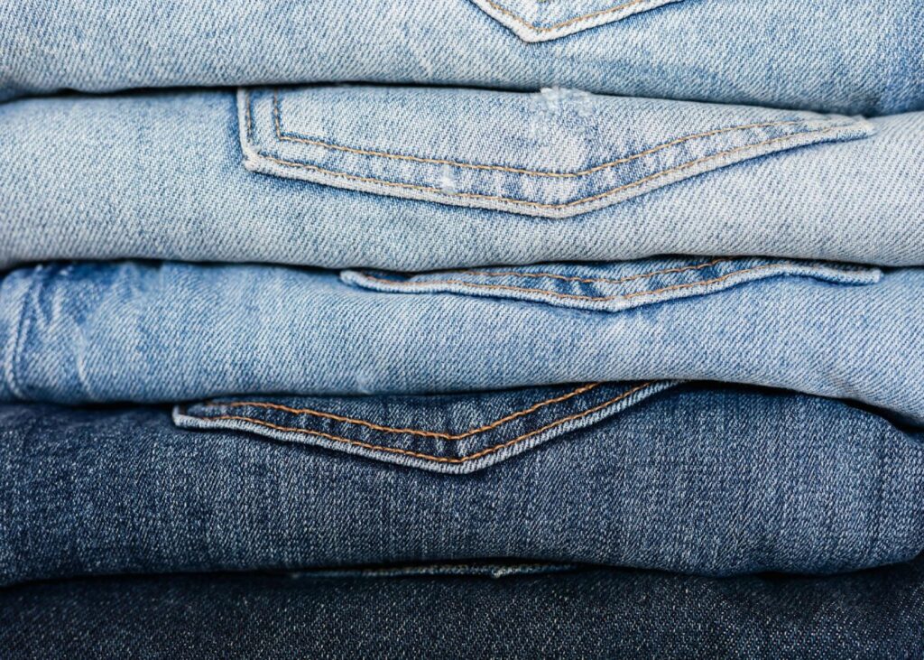 folded jeans in a pile