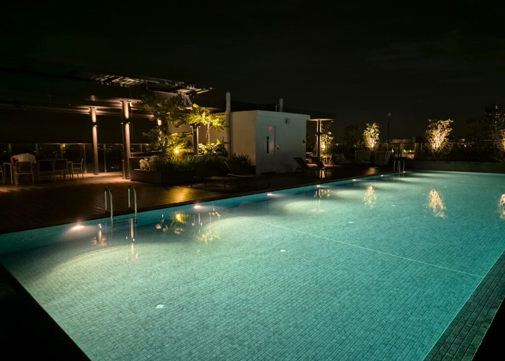 view of a rooftop pool at night